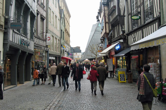 Street with big clock in Rouen